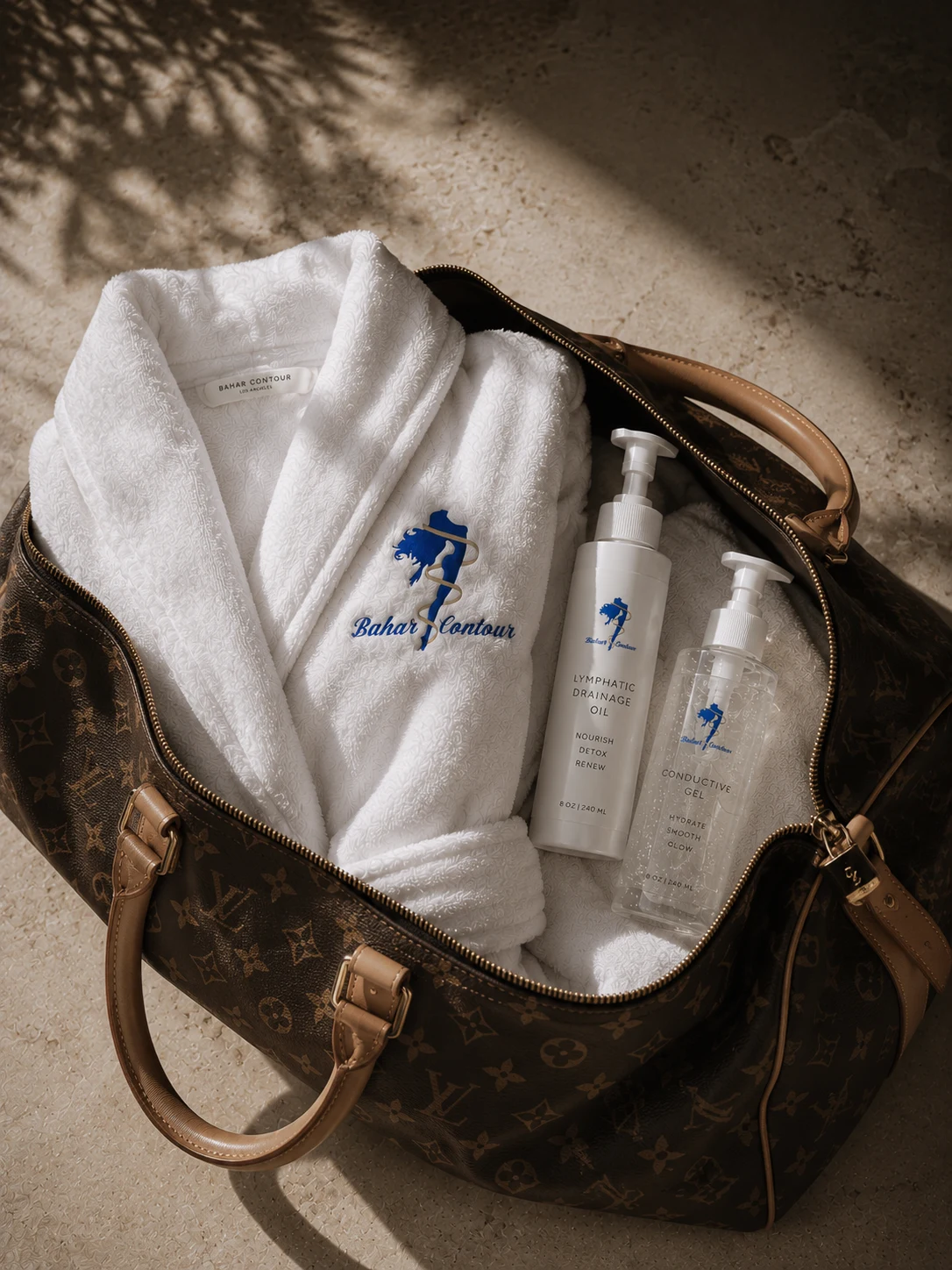 Bahar Contour embroidered robe and treatment oils, ready for a private session